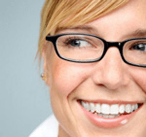 woman with glasses smiling