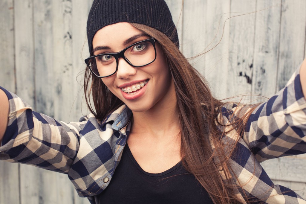 Hipster girl in glasses and braces