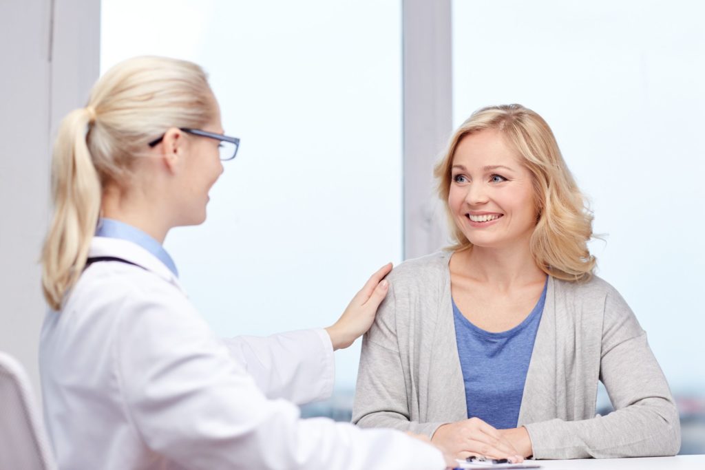 doctor talking to woman patient