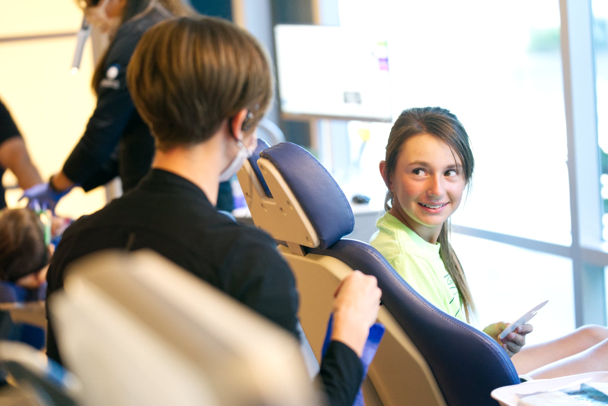 Patient smiling in orthodontic chair during braces treatment in Sacramento